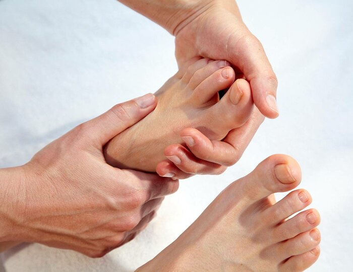Foot reflexology massage at Kristall Spa A therapist performs foot reflexology massage on a guest's sole in the Kristall Spa.
