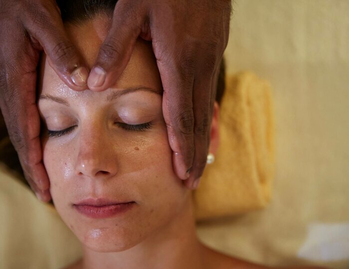 Shiro-Padabhyanga treatment at Kristall Spa A person receives a Shiro-Padabhyanga treatment with a gentle head massage at Kristall Spa.